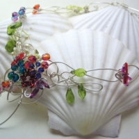 Celtic Garden A garden of hand-wired firepolished glass flowers on a celtic-inspired heavy silver wire base.